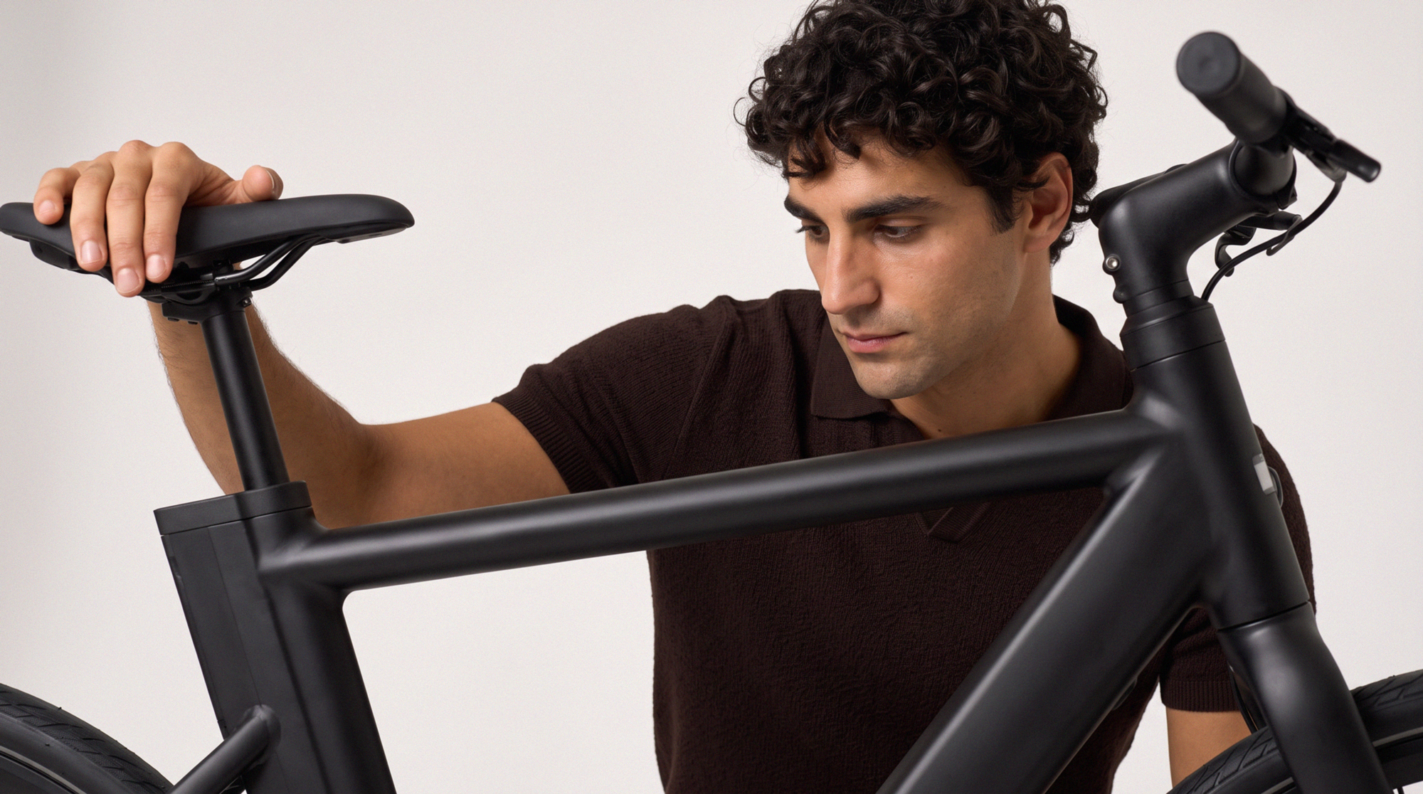 Man holding an e-bike frame, annotated with the atoms of the scene.