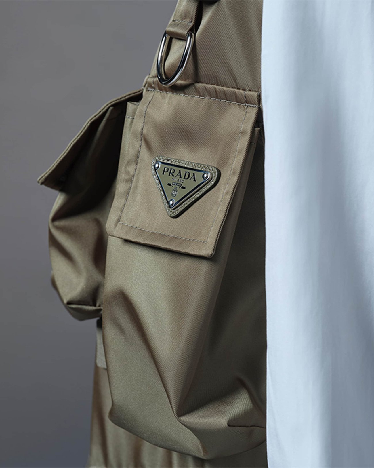 Olive Re-Nylon garment detail with the Prada triangle